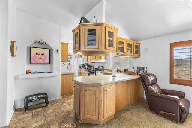 a view of kitchen with stainless steel appliances granite countertop a sink stove and cabinets