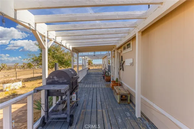 a view of balcony with wooden floor and outdoor seating