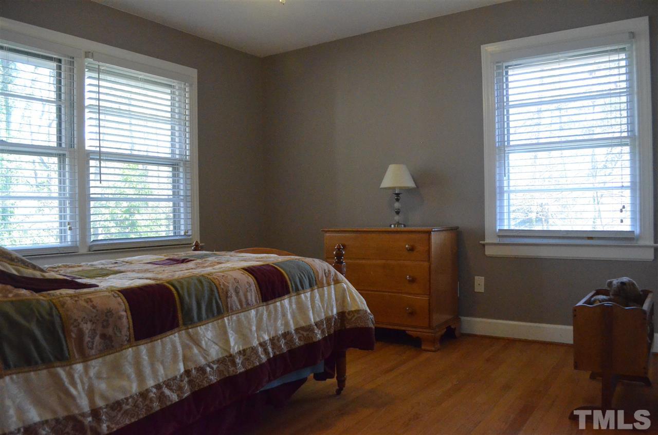 5311 Alpine Drive Raleigh, NC 27609 - Photo 11 of 25 a bed sitting in a bedroom next to a window