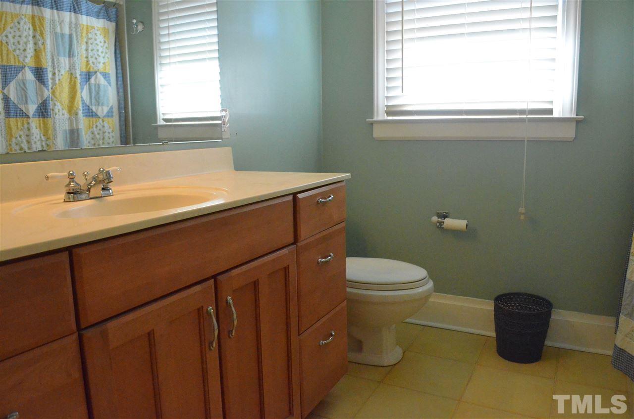 5311 Alpine Drive Raleigh, NC 27609 - Photo 12 of 25 a bathroom with a sink and a toilet