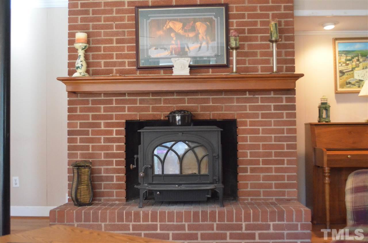 5311 Alpine Drive Raleigh, NC 27609 - Photo 16 of 25 a fireplace with a wooden floor