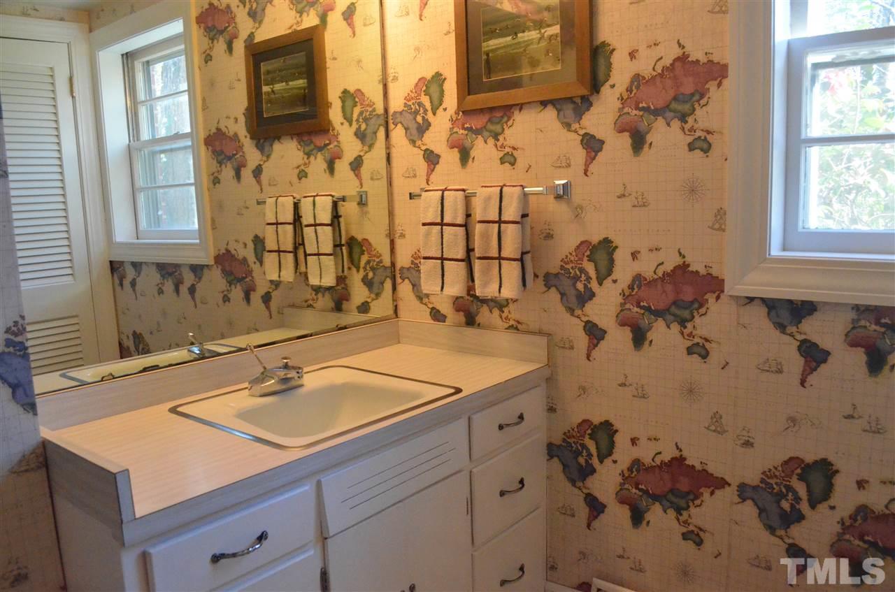 5311 Alpine Drive Raleigh, NC 27609 - Photo 19 of 25 a bathroom with a sink and a mirror