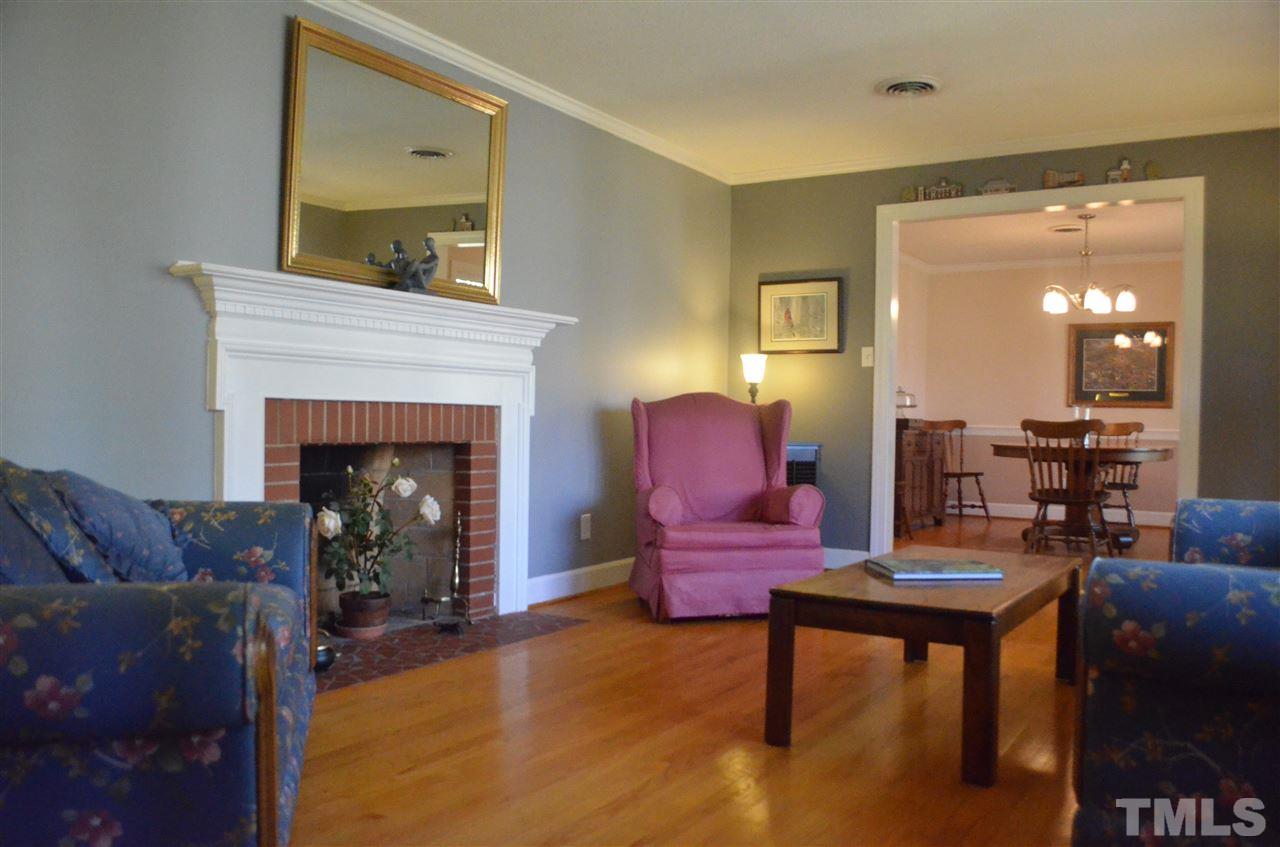 5311 Alpine Drive Raleigh, NC 27609 - Photo 5 of 25 a living room with furniture and a fireplace
