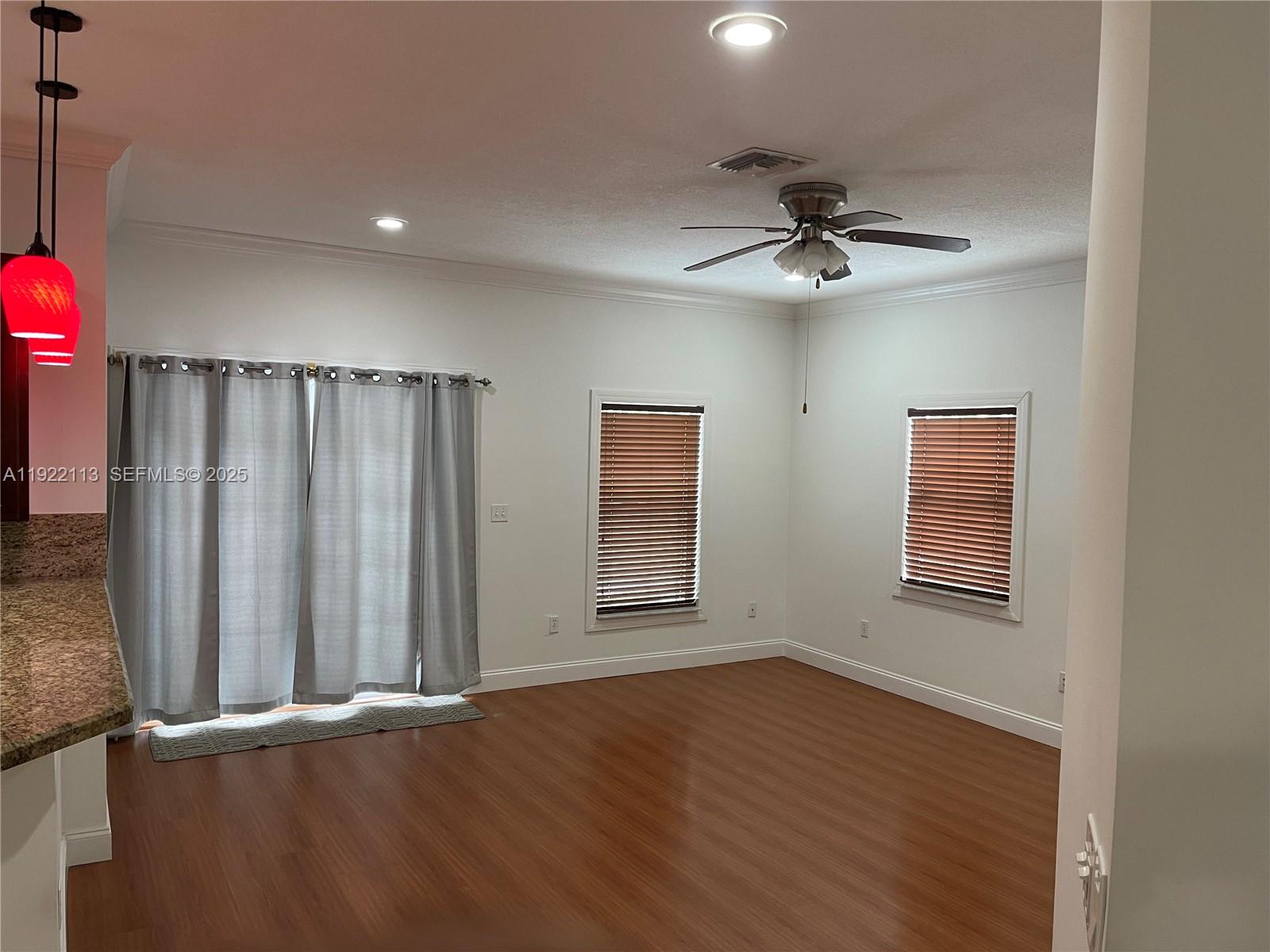 425 Northwest 135th Street North Miami, FL 33168 - Photo 4 of 12 an empty room with wooden floor closet and windows