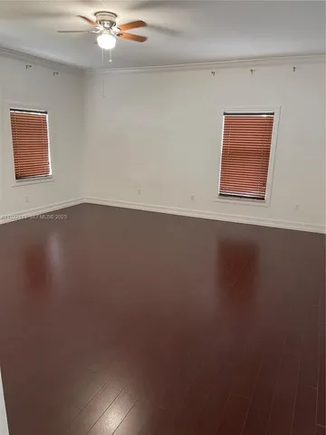 a view of a room with wooden floor and window