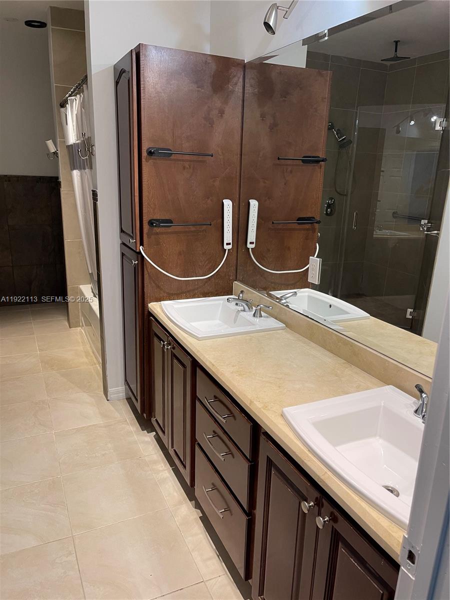425 Northwest 135th Street North Miami, FL 33168 - Photo 6 of 12 a bathroom with a double vanity sink and a mirror