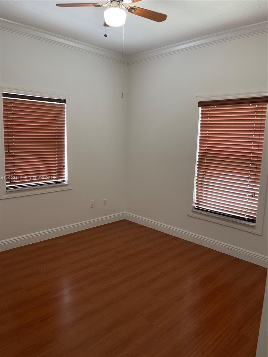 425 Northwest 135th Street North Miami, FL 33168 - Photo 7 of 12 a view of an empty room with wooden floor and a window