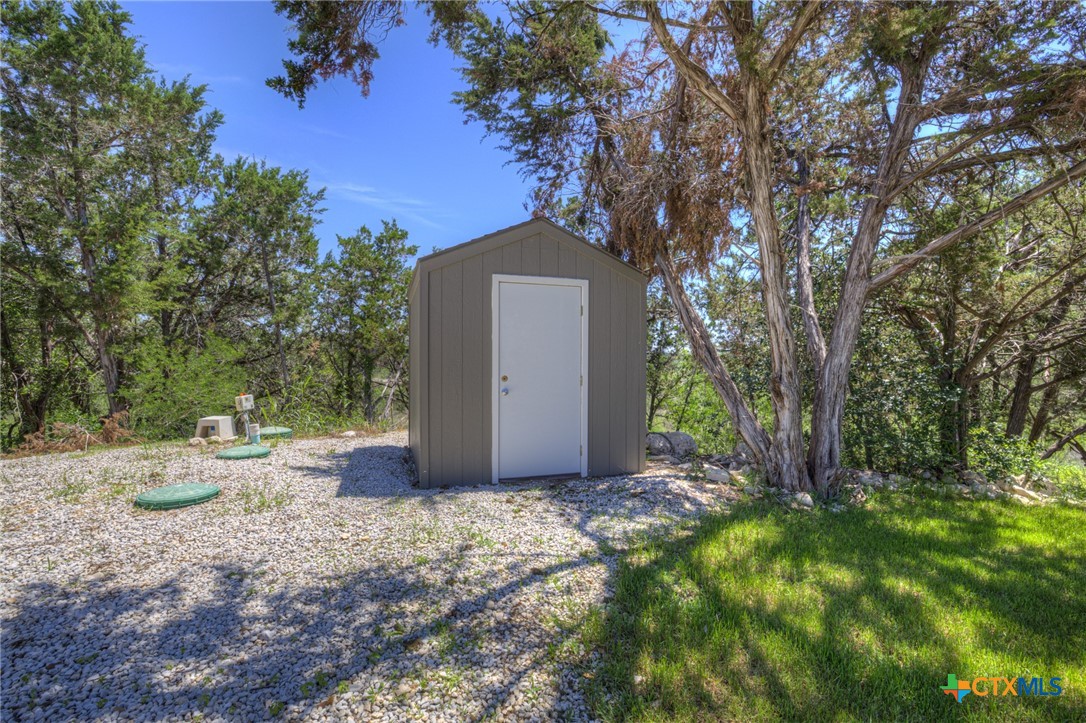 305 Lake Crest Spring Branch, TX 78070 - Photo 29 of 38 a backyard of a house with a tree