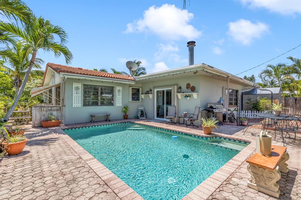 1931 Northeast 27th Street Lighthouse Point, FL 33064 - Photo 1 of 28 a front view of a house with swimming pool having outdoor seating
