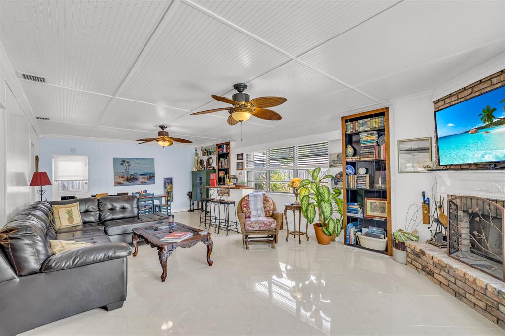 1931 Northeast 27th Street Lighthouse Point, FL 33064 - Photo 17 of 28 a living room with furniture and a flat screen tv