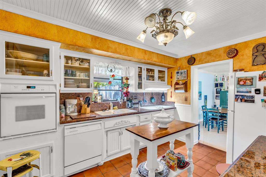 1931 Northeast 27th Street Lighthouse Point, FL 33064 - Photo 20 of 28 a kitchen with stainless steel appliances granite countertop a sink and cabinets