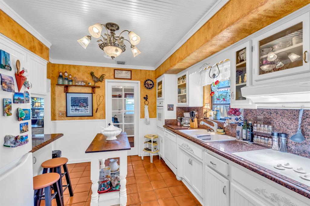 1931 Northeast 27th Street Lighthouse Point, FL 33064 - Photo 21 of 28 a large white kitchen with a large window