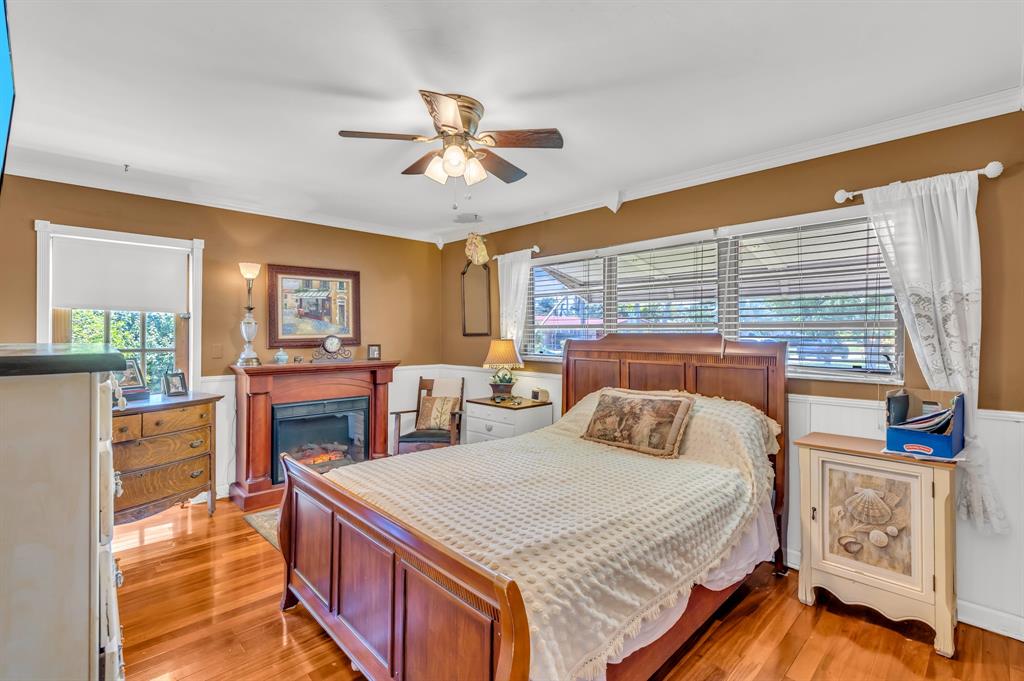 1931 Northeast 27th Street Lighthouse Point, FL 33064 - Photo 22 of 28 a bedroom with a bed and a chandelier