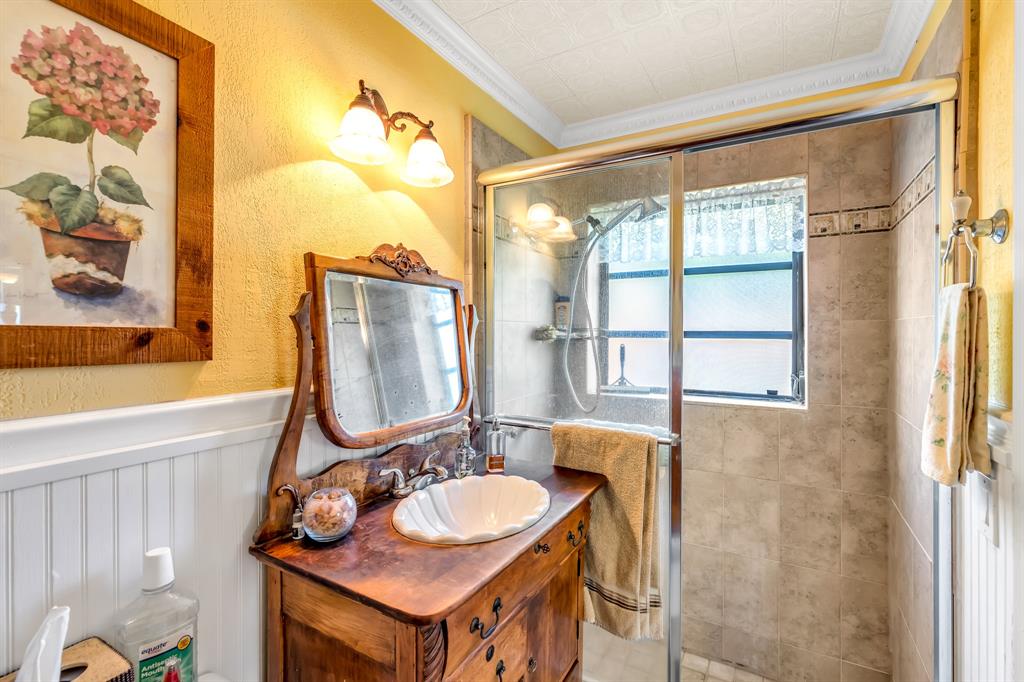 1931 Northeast 27th Street Lighthouse Point, FL 33064 - Photo 24 of 28 a bathroom with a sink and a mirror