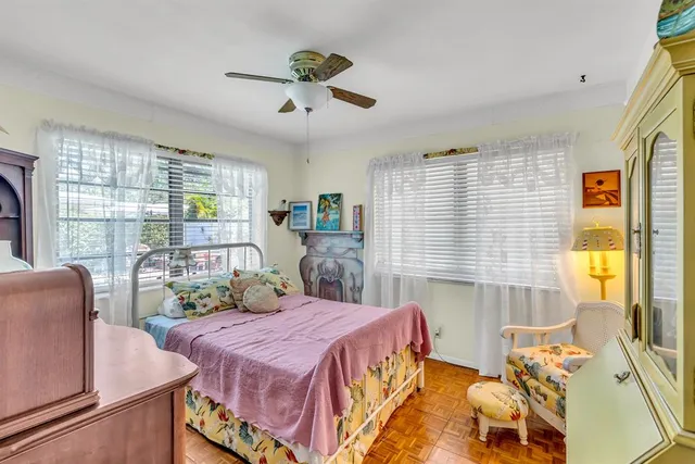a bedroom with furniture and a potted plant