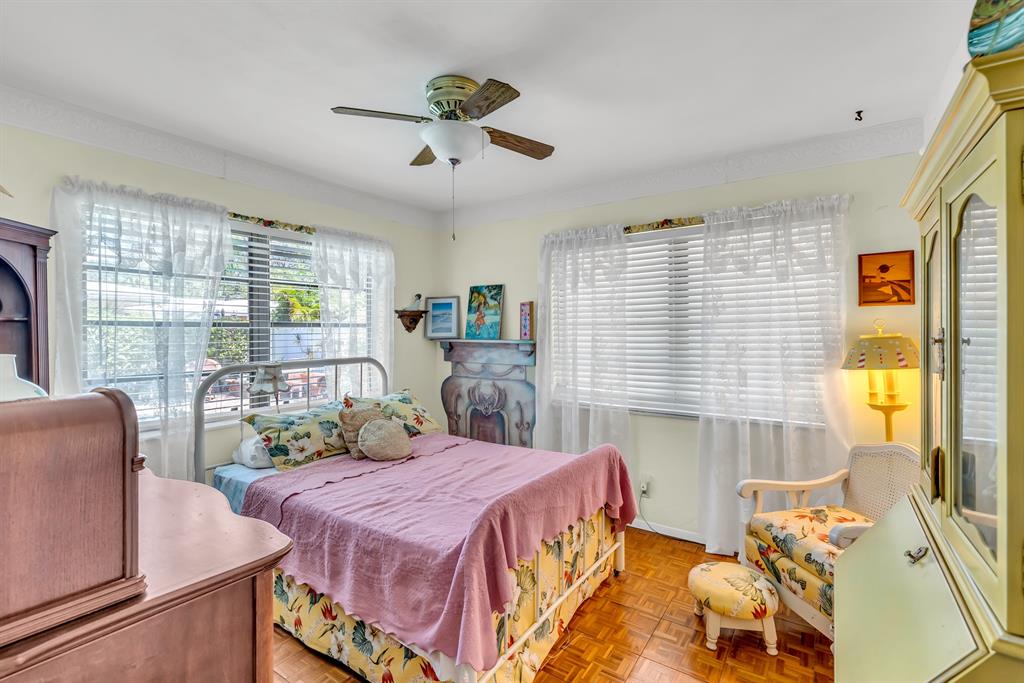 1931 Northeast 27th Street Lighthouse Point, FL 33064 - Photo 25 of 28 a bedroom with a bed and a large window with the outer view