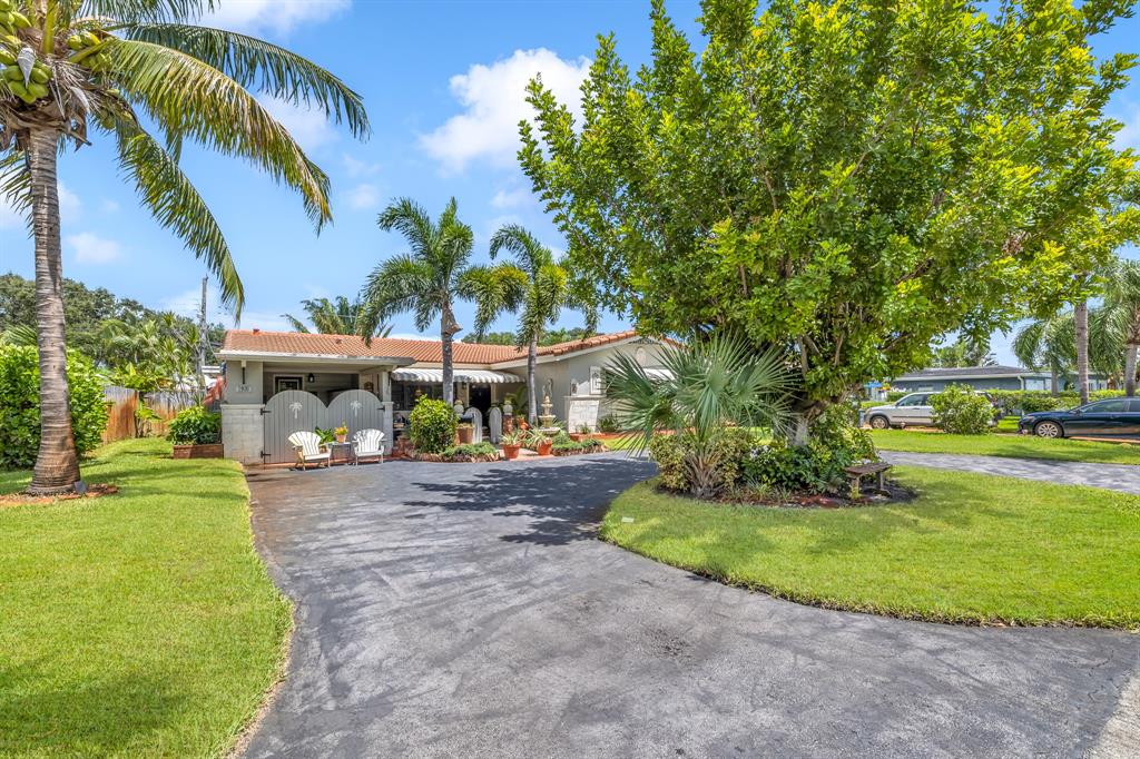 1931 Northeast 27th Street Lighthouse Point, FL 33064 - Photo 6 of 28 a front view of a house with garden