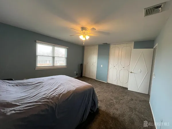 a living room with furniture a ceiling fan and a rug