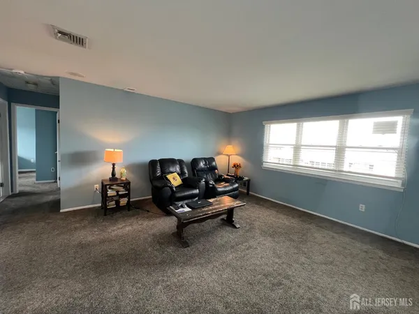 a kitchen with kitchen island granite countertop a sink a counter space appliances and cabinets