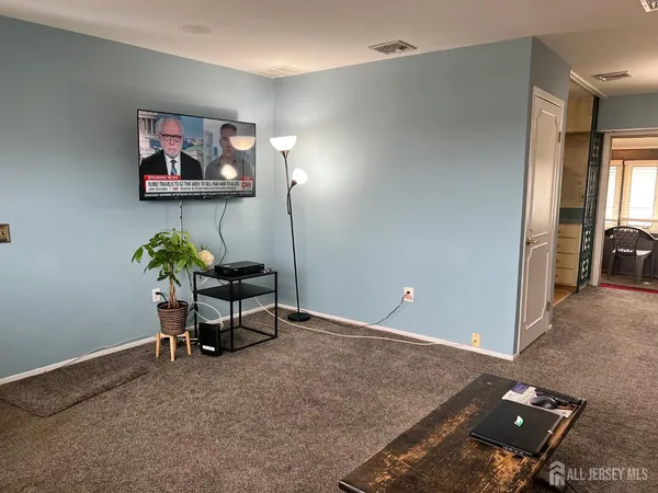a room with a chandelier and a window