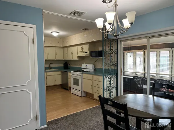 a view of a dining room with furniture wooden floor and chandelier