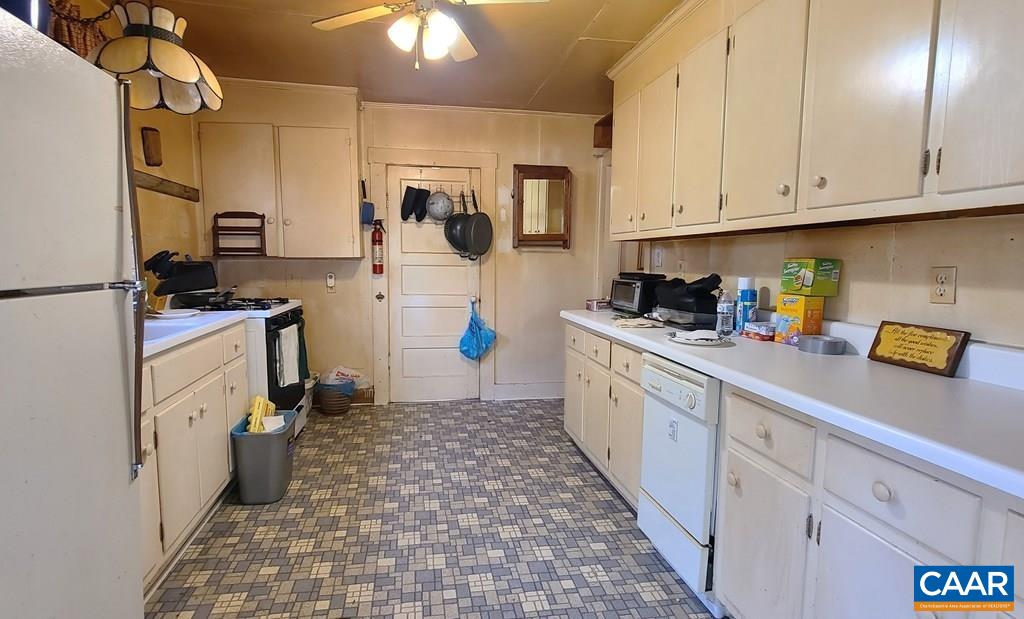 3689 Ranson Road Dillwyn, VA 23936 - Photo 17 of 51 a kitchen with a sink a stove top oven a refrigerator and cabinets