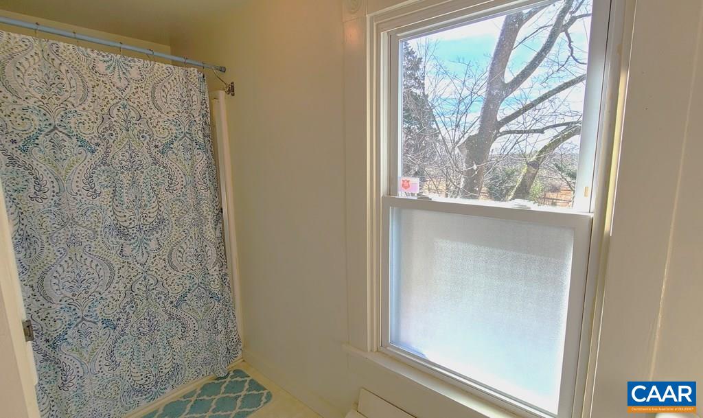 3689 Ranson Road Dillwyn, VA 23936 - Photo 23 of 51 a bathroom with a shower curtain and window