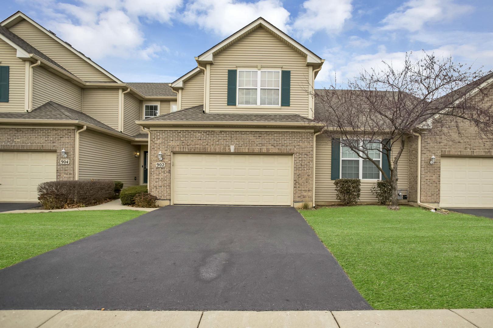 902 Oak Ridge Boulevard Elgin, IL 60120 - Photo 1 of 35 a front view of a house with a yard and garage