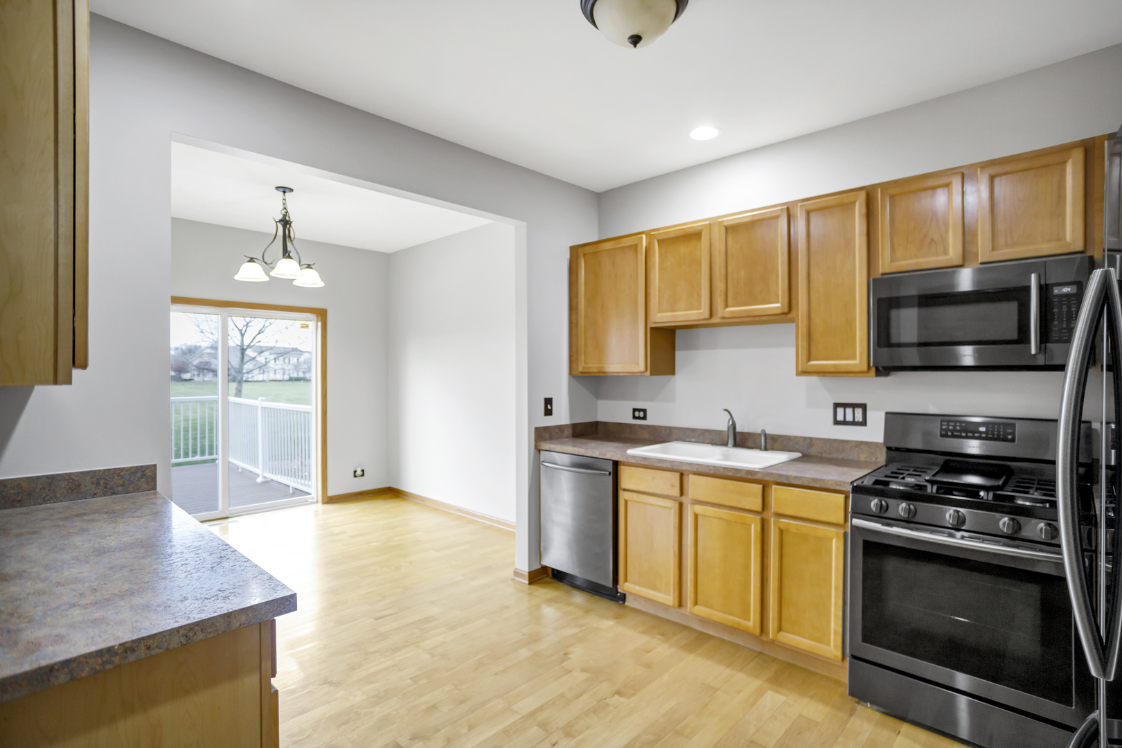 902 Oak Ridge Boulevard Elgin, IL 60120 - Photo 11 of 35 a kitchen with stainless steel appliances granite countertop a stove a sink and a microwave