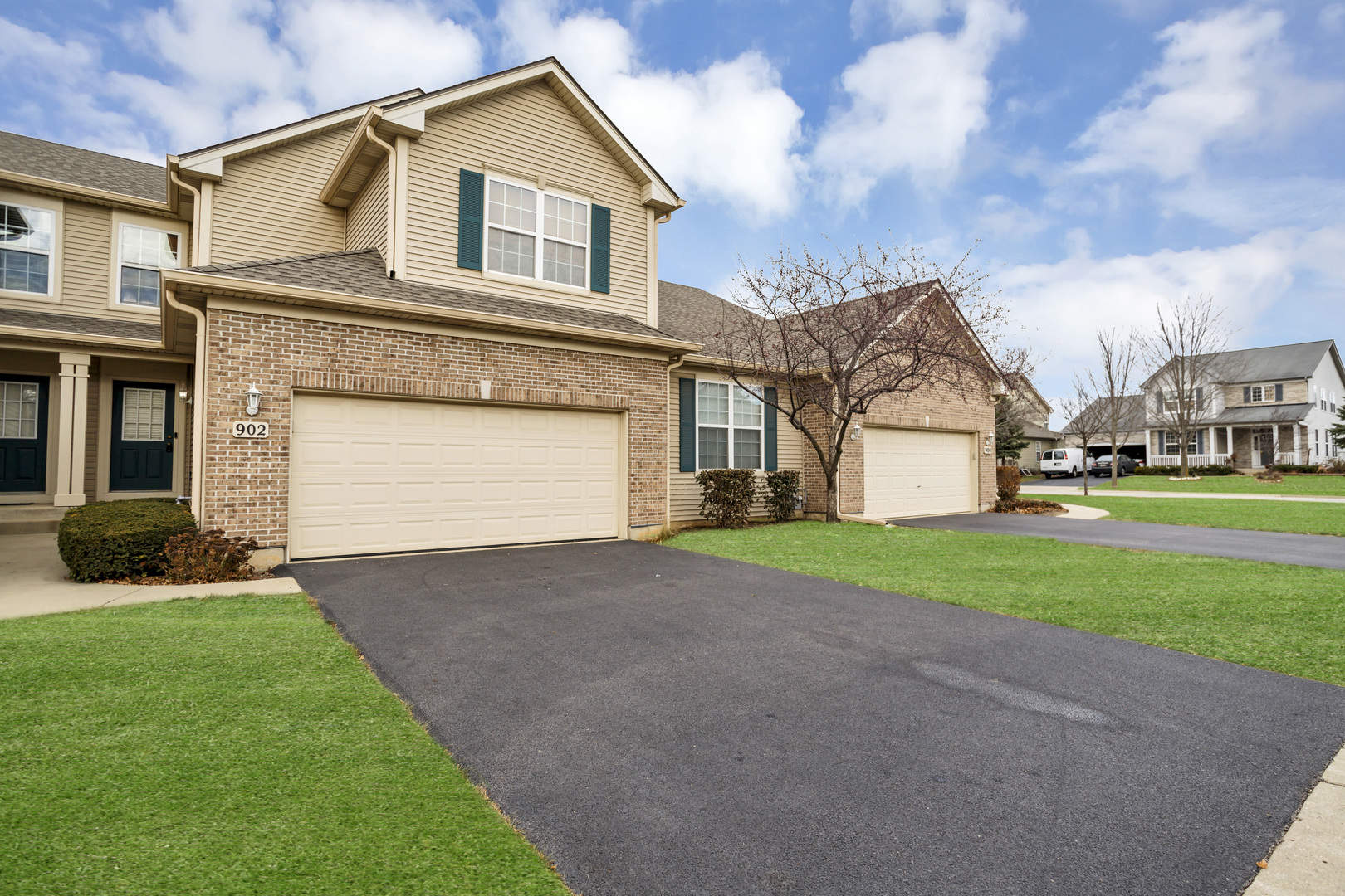 902 Oak Ridge Boulevard Elgin, IL 60120 - Photo 2 of 35 a view of a white house with a small yard and large trees