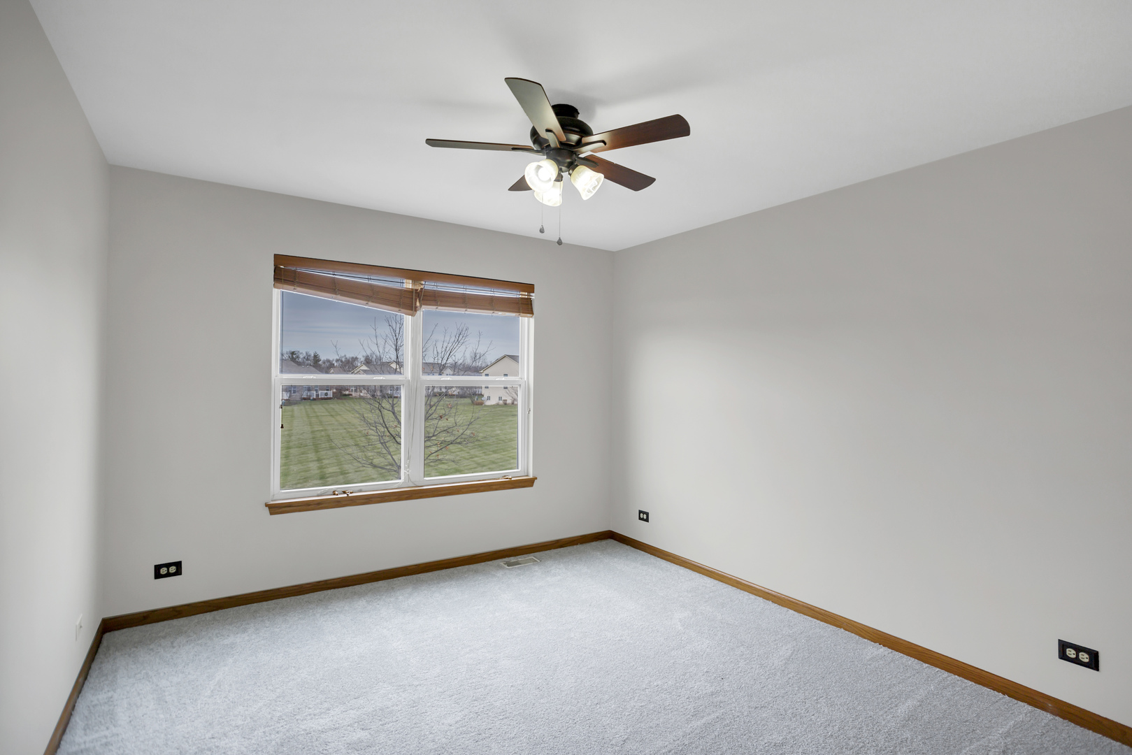 902 Oak Ridge Boulevard Elgin, IL 60120 - Photo 22 of 35 an empty room with a window and a ceiling fan