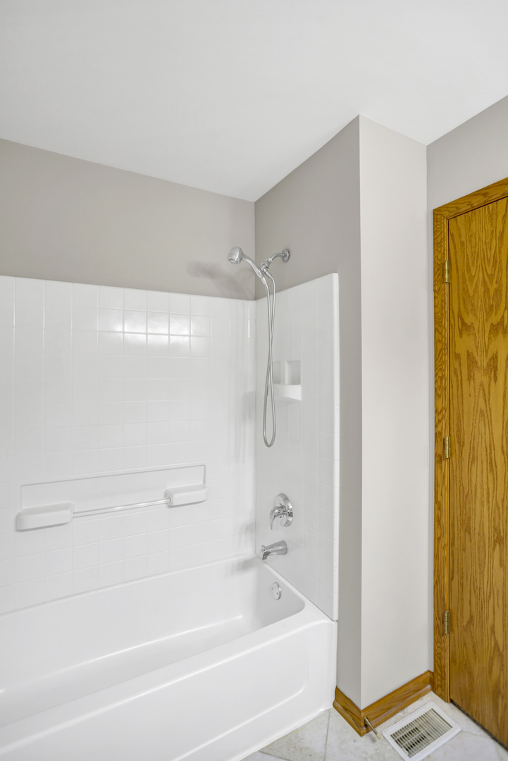 902 Oak Ridge Boulevard Elgin, IL 60120 - Photo 29 of 35 a bathroom with a bathtub and a shower