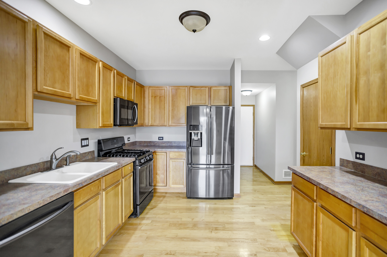 902 Oak Ridge Boulevard Elgin, IL 60120 - Photo 10 of 35 a kitchen with stainless steel appliances granite countertop a sink stove refrigerator and cabinets