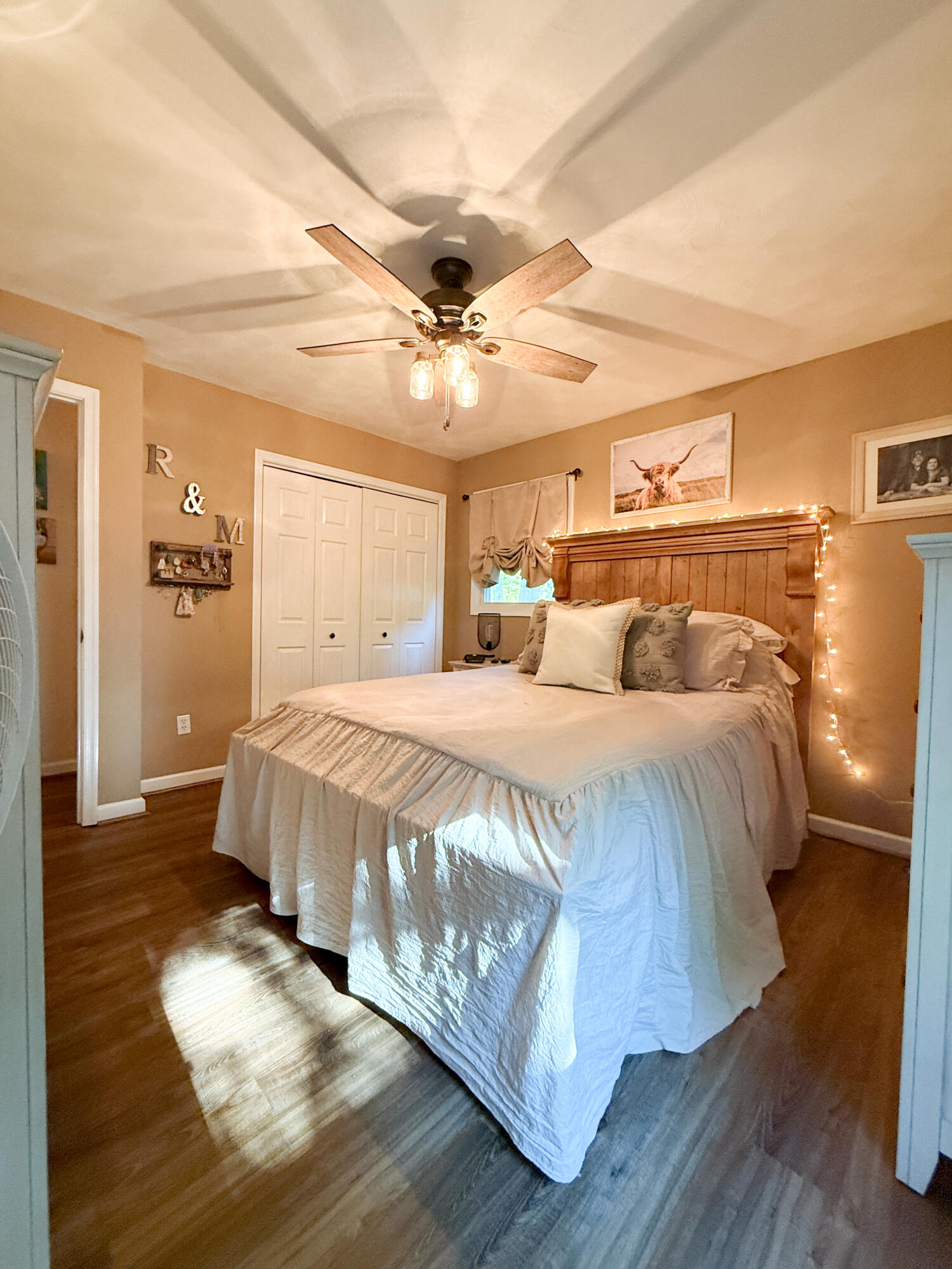2768 Sandy Level Road Goodview, VA 24095 - Photo 20 of 56 a spacious bedroom with a bed and a ceiling fan