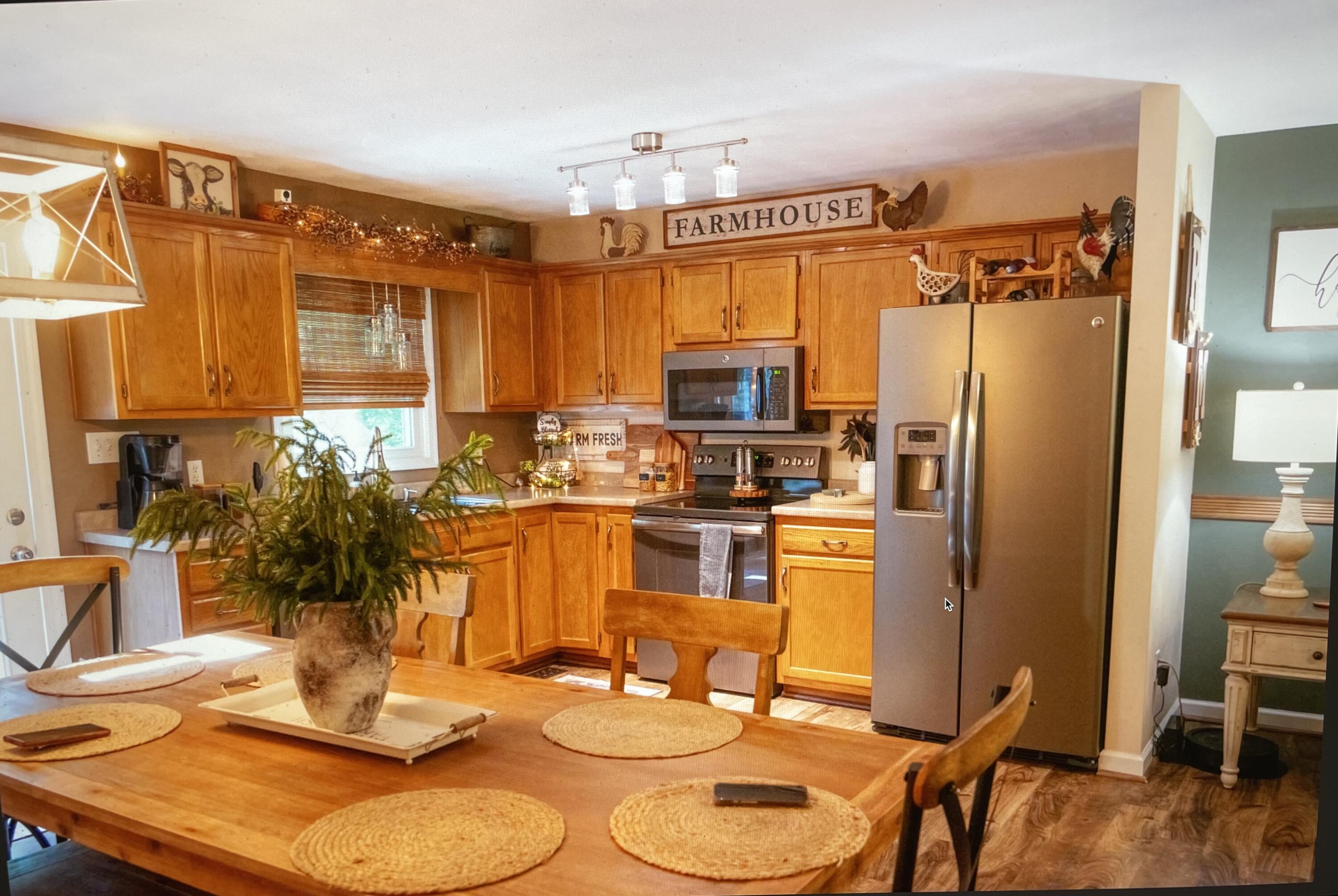 2768 Sandy Level Road Goodview, VA 24095 - Photo 6 of 56 a kitchen with a refrigerator and a dining table