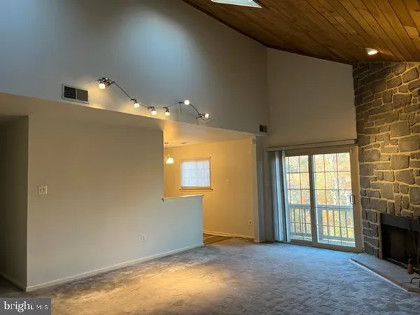 a view of an empty room with a fireplace