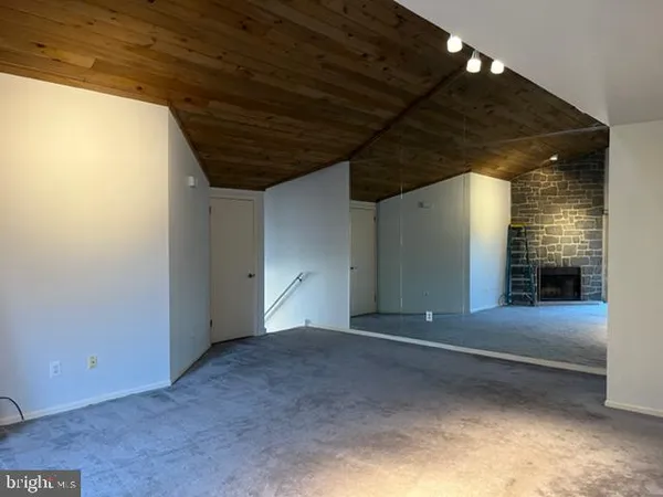 a view of an empty room with a fireplace