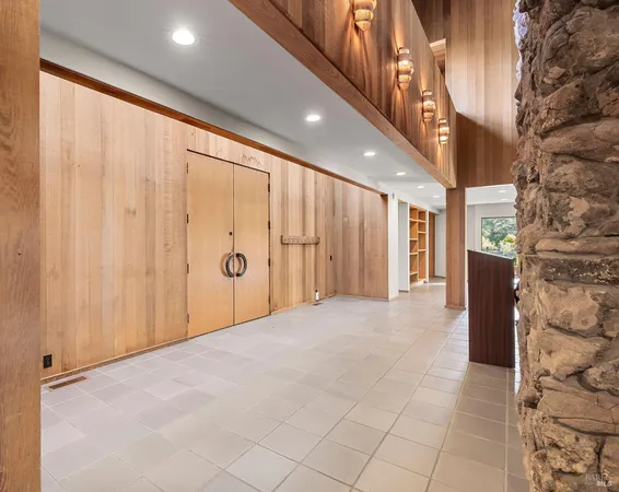 a view of empty room with fireplace and window