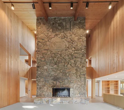 a view of an empty room with a fireplace and a window