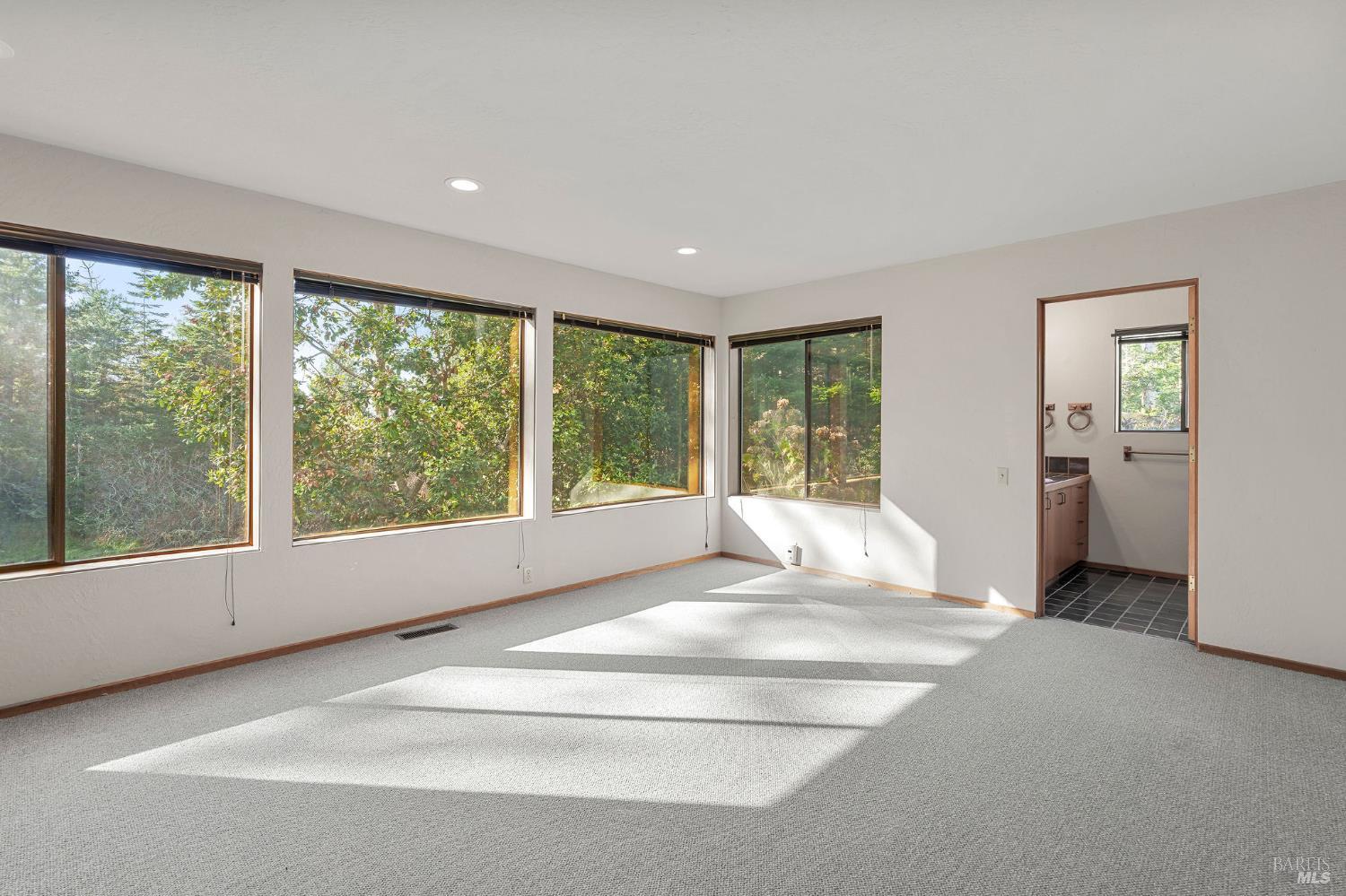 36029 Timber Ridge Road The Sea Ranch, CA 95497 - Photo 27 of 59 a spacious bedroom with a large bed and a large window