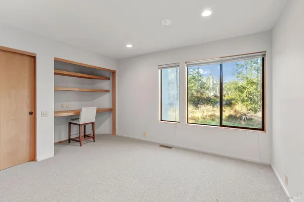 a large kitchen with kitchen island granite countertop a large window and a sink
