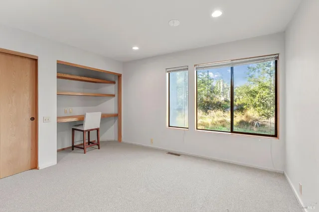 a large kitchen with kitchen island granite countertop a large window and a sink