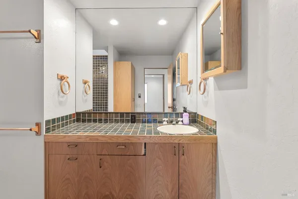 a large white kitchen with a large window