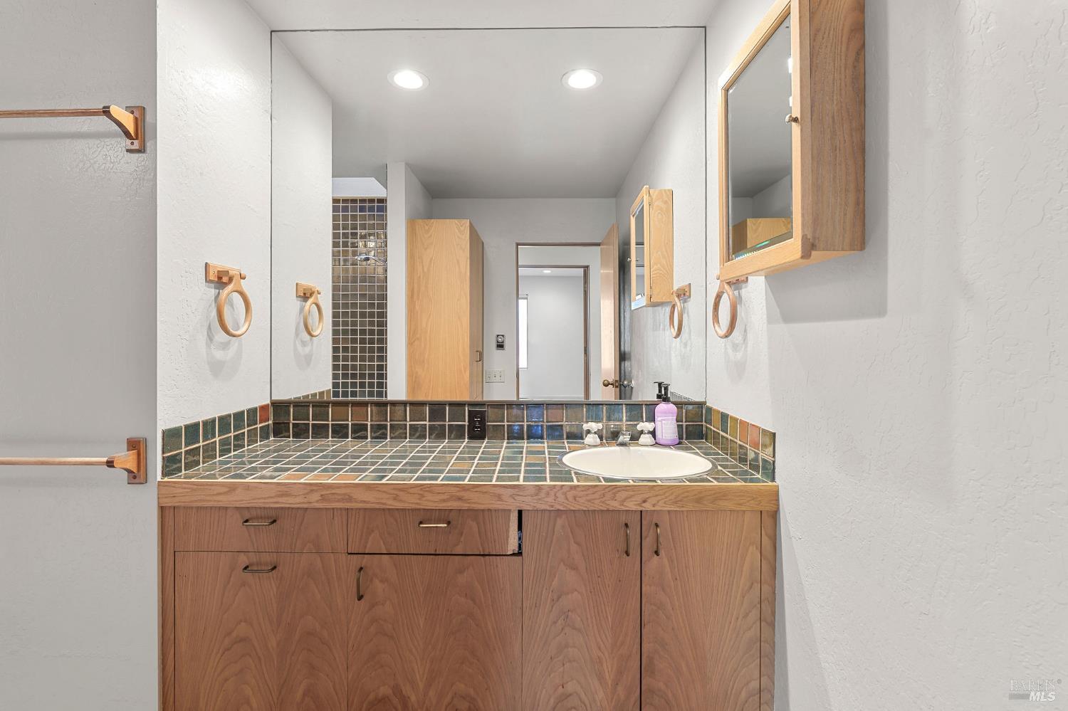 36029 Timber Ridge Road The Sea Ranch, CA 95497 - Photo 32 of 59 a bathroom with a granite countertop sink and a mirror