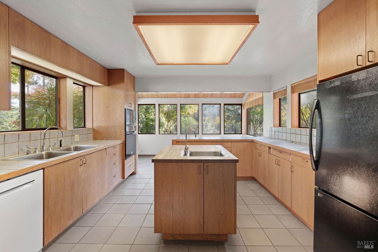 36029 Timber Ridge Road The Sea Ranch, CA 95497 - Photo 35 of 59 a large kitchen with kitchen island granite countertop a large window and a sink