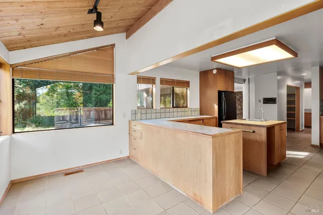 a kitchen with granite countertop a sink and cabinets
