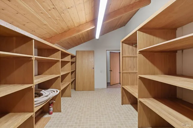 a view of an empty room with a fireplace and a window