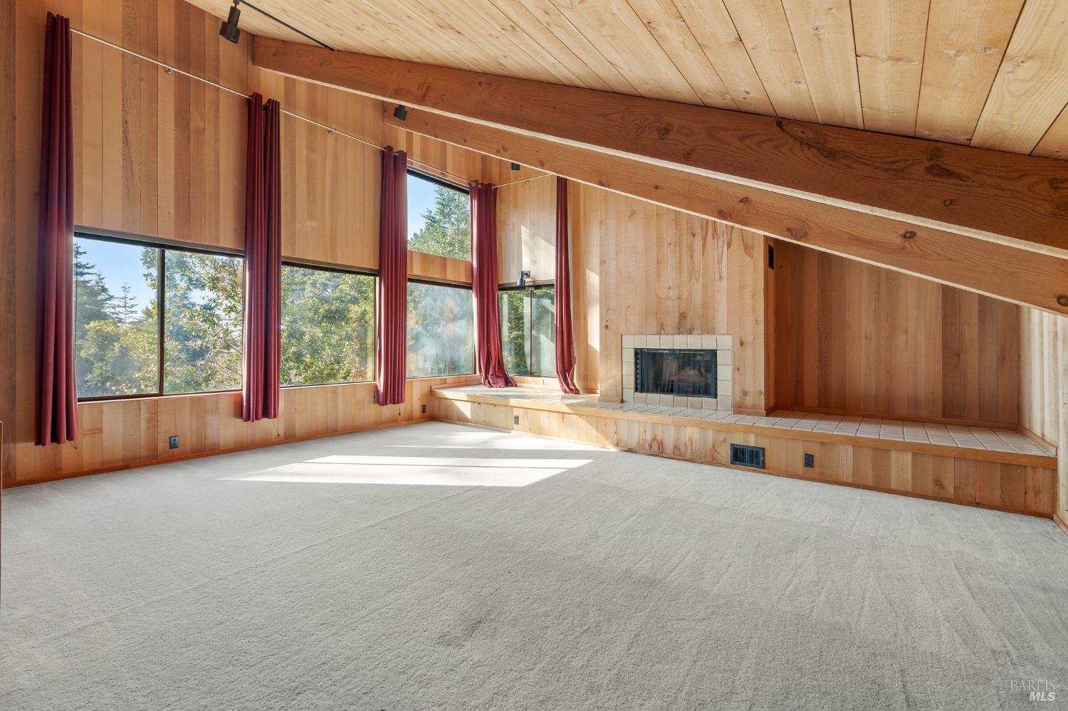 36029 Timber Ridge Road The Sea Ranch, CA 95497 - Photo 45 of 59 a view of an empty room with a fireplace and a window