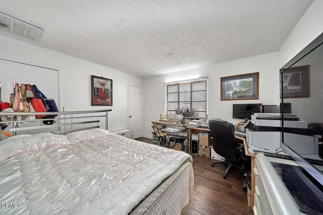 a living room with furniture a flat screen tv and a table