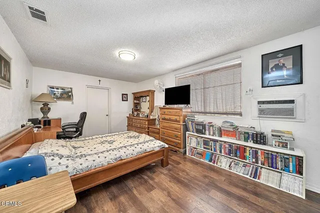 a bedroom with furniture and a flat screen tv